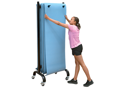Girl hanging a yoga mat on a rack.